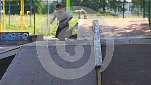 Young man is skating on skateboard in skate park. Extreme, sport concept