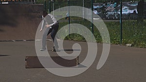 Young man is skating on skateboard in skate park. Freedom, sport concept.