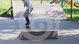 Young man is skating on skateboard in skate park. Lifestyle hipster concept