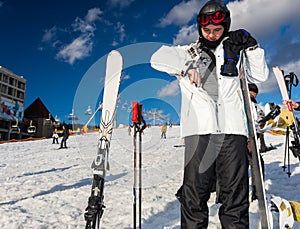 Young man in ski-suit, helmet and ski goggles gets a pass from t