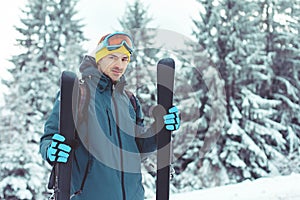 Young man skier enjoying winter in mountains
