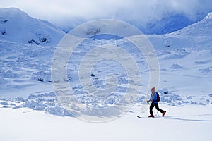 Young man skiing in the Retezat Mountains in a beautiful sunny day.