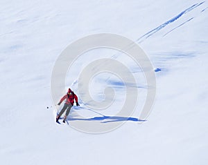 Young man skiing in the Retezat Mountains in a beautiful sunny day.