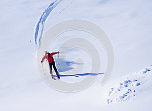 Young man skiing in the Retezat Mountains in a beautiful sunny day.
