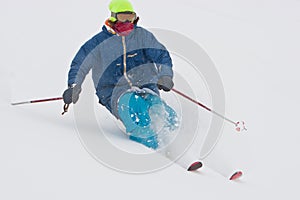 Young man skiing in snowstorm