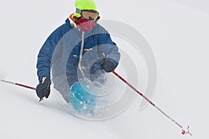 Young man skiing in snowstorm