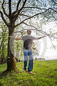 Young man slacklining
