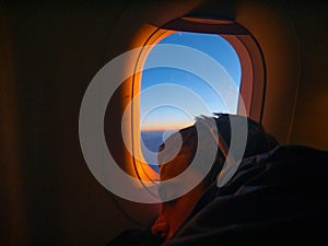 Young man sleep in the airplane