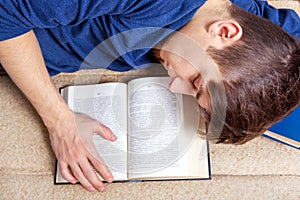 Young Man sleep with a Book