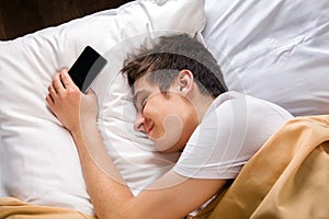 Young Man sleep with a Phone