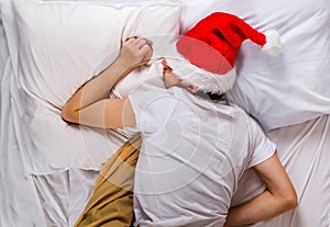 Young Man sleep in Santa Hat