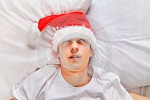 Young Man sleep in Santa Hat
