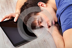 Young man sleep with a tablet