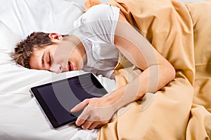Young Man sleep with a Tablet