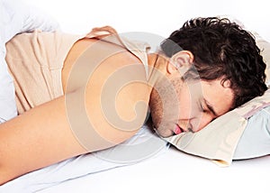 Young man sleeping in bed