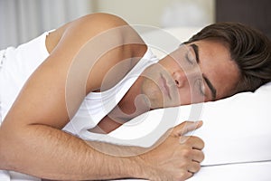 Young Man Sleeping On Bed