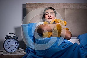 The young man sleeping in the bed