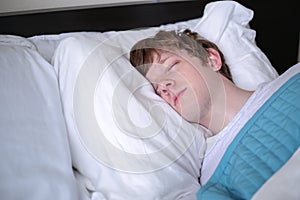 Young Man Sleeping in Bed - Close-up