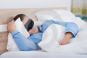 Young Man Sleeping On Bed