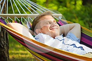 Young man sleeping in a hammock