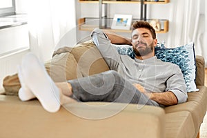 Young man sleeping on sofa at home
