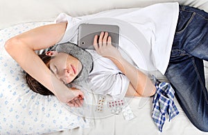 Young Man sleeps with Tablet Computer