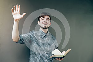 Young man smile and reading the bible book