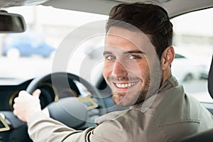 Young man smiling while driving