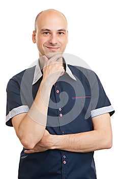 Young man smiling with hand on chin