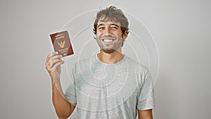 Young man smiling holding passport of thailand over isolated white background