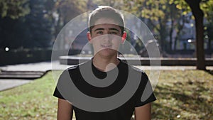 Young man smiling and looking at camera. Portrait of a happy handsome young man in a urban street. Close up