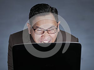 Young Man Smiling When Looking at Laptop