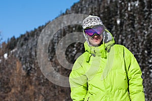 Young man smiling in ski mask