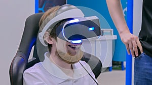 Young man smiling and using virtual reality headset
