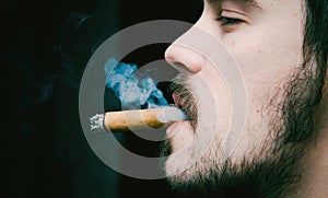 Young man smoking cigar