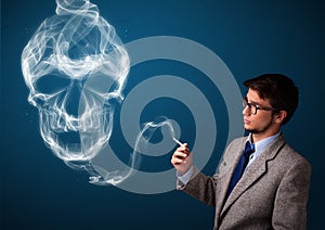 Young man smoking dangerous cigarette with toxic skull smoke