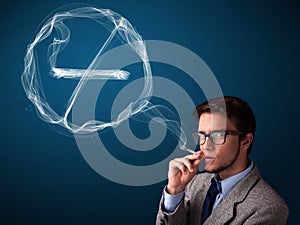 Young man smoking unhealthy cigarette with no smoking sign