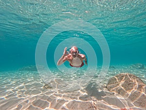 Young man snorkeling in crystal clear waters
