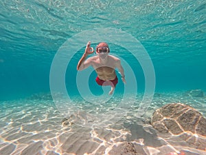 Young man snorkeling in crystal clear waters