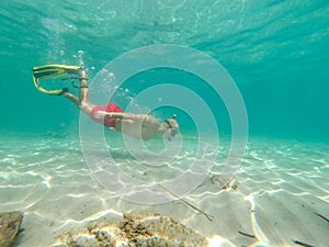 Young man snorkeling in crystal clear wates