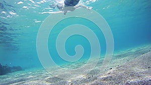 Young Man Snorkeling and Floating Through the Frame, Underwater View in Red Sea, Egypt