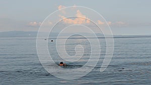 Young man with snorkeling mask go swimming in the peaceful ocean.