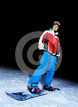 Young man on snowboard at night