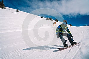 Young man snowboarding in the Austrian Alps