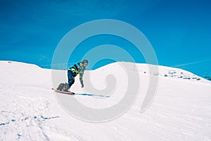 Young man snowboarding in the Austrian Alps