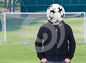 Young man with a soccer ball instead of the head