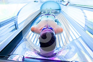 Young Man At Solarium In Beauty Salon