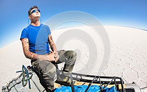 Young man solo traveler taking relax break at Salar de Uyuni Bolivia