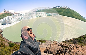 Young man solo traveler taking selfie at Perito Moreno glaciar