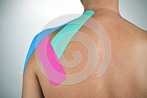 Young man with some strips of elastic therapeutic tape in his ba